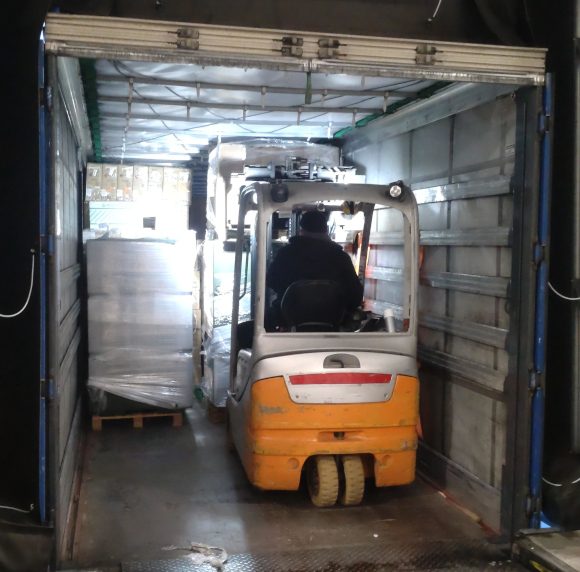 A truck being loaded with donated IT equipment.